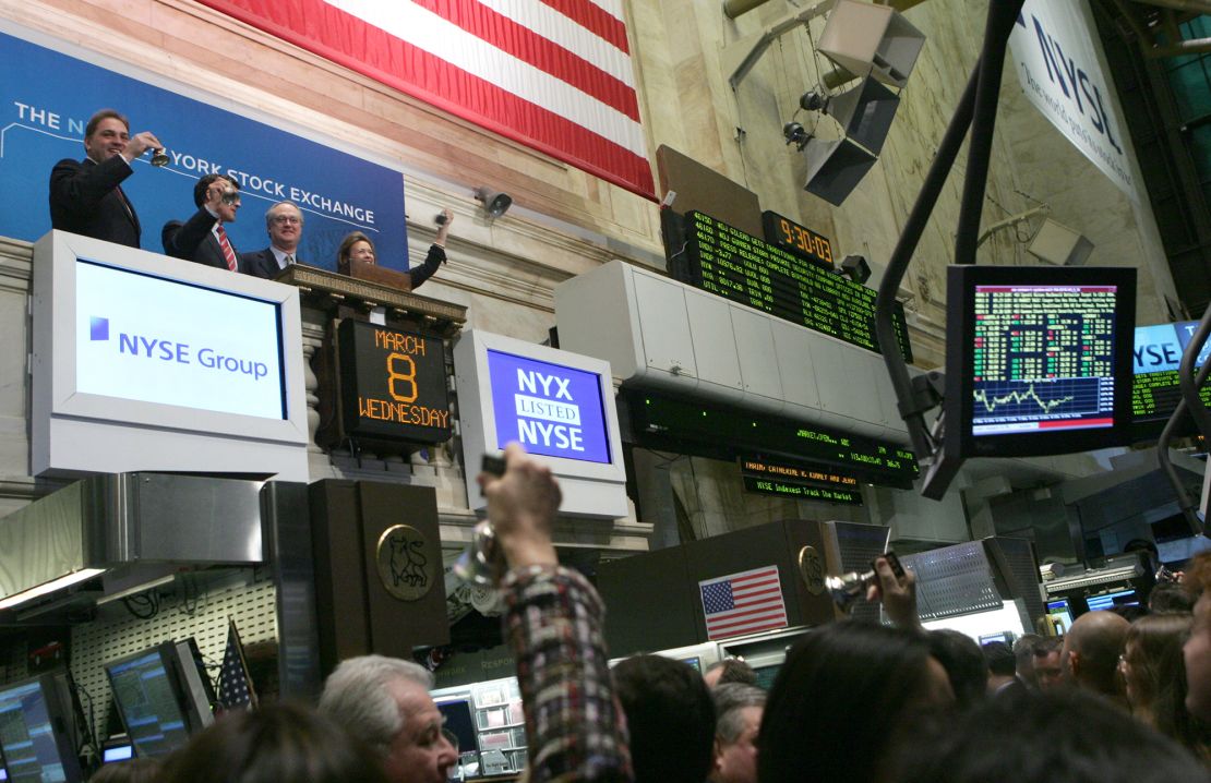 From left to right on balcony, Gerald Putnam, CEO of Archipelago Holdings, John Thain, CEO of the New York Stock Exchange, Marshall Carter, Chairman of the NYSE, and Catherine Kinney, President and co-COO of the NYSE, celebrate the listing of the exchange as a publicly traded company Wednesday, March 8, 2006 in New York.