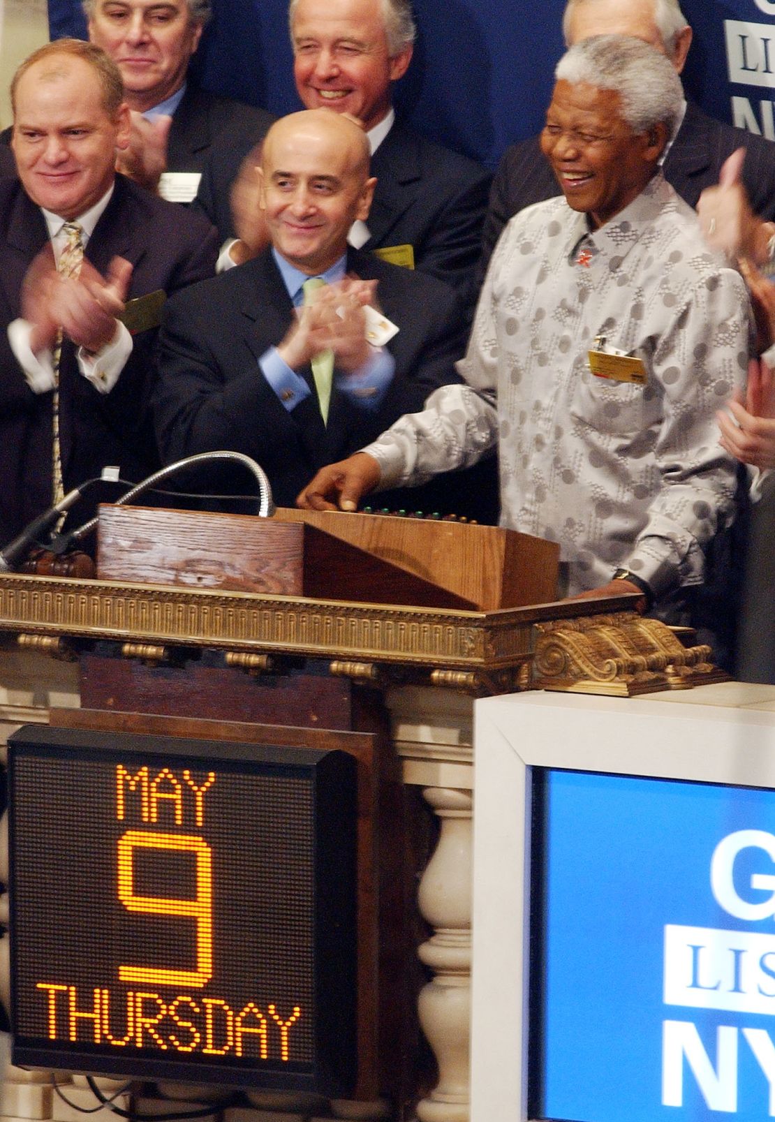 Former South African President Nelson Mandela (R) rings ringing the opening bell at the New York Stock Exchange May 9, 2002 in New York as NYSE Chairman Richard Grasso (C) applauds.
